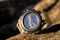 Close-up of a rugged sports watch, perfect for outdoor adventures, resting on a rock.